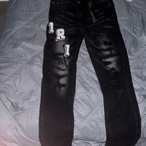 Black Amiri Varsity logo jeans